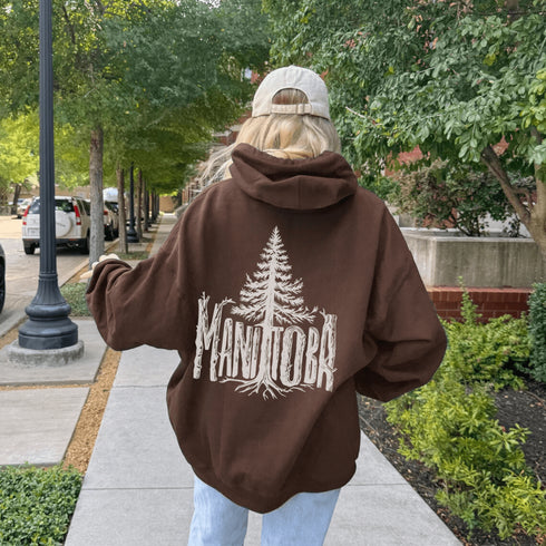 Celebrate the wild spirit of Manitoba with this eye-catching hoodie featuring "Manitoba" written in a unique tree branch font.